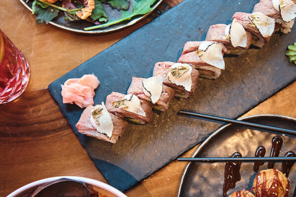 sushi platter with assorted rolls and garnishes